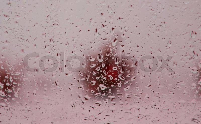 Wet glass with drops of rain fall on the street, stock photo