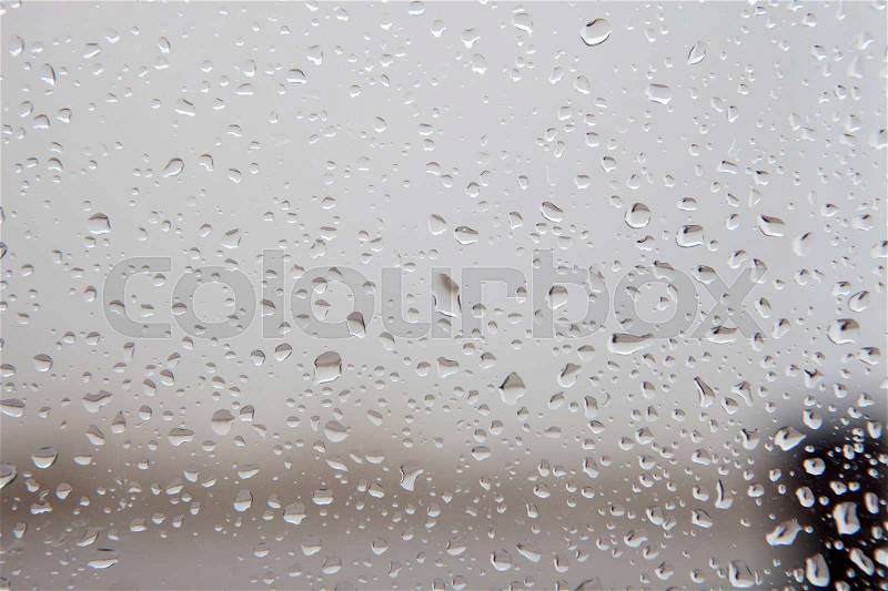 Wet glass with drops of rain fall on the street,, stock photo