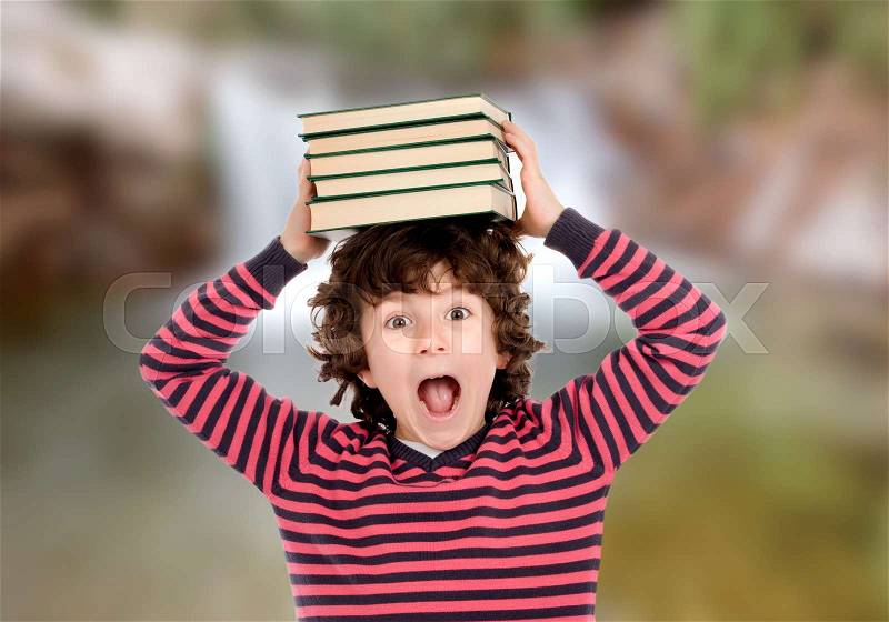 Crazy child with books on his head shouting, stock photo