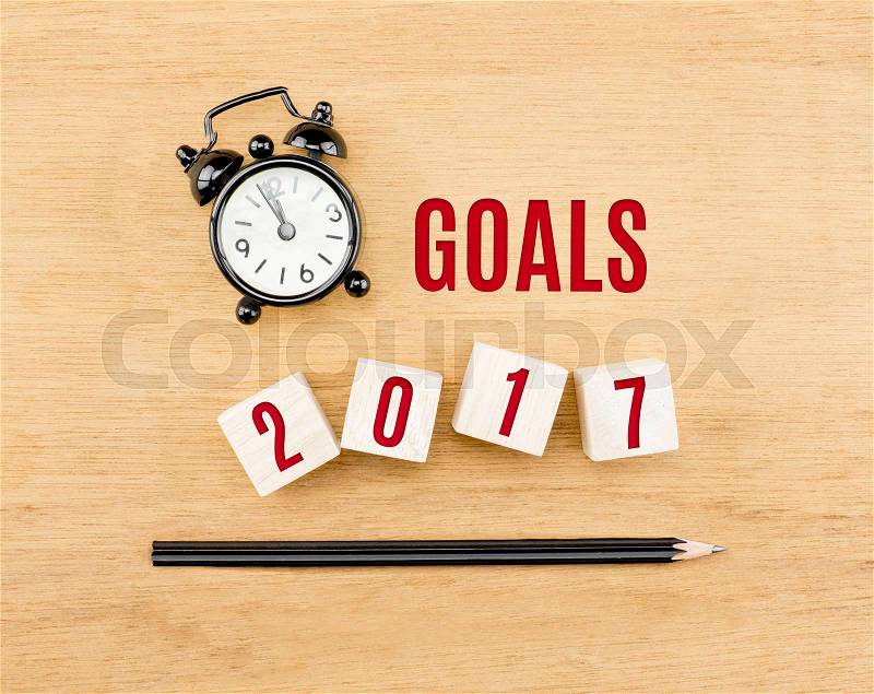 Goals 2017 year on wood cube with pencil and clock top view on wood table,New year business concept, stock photo