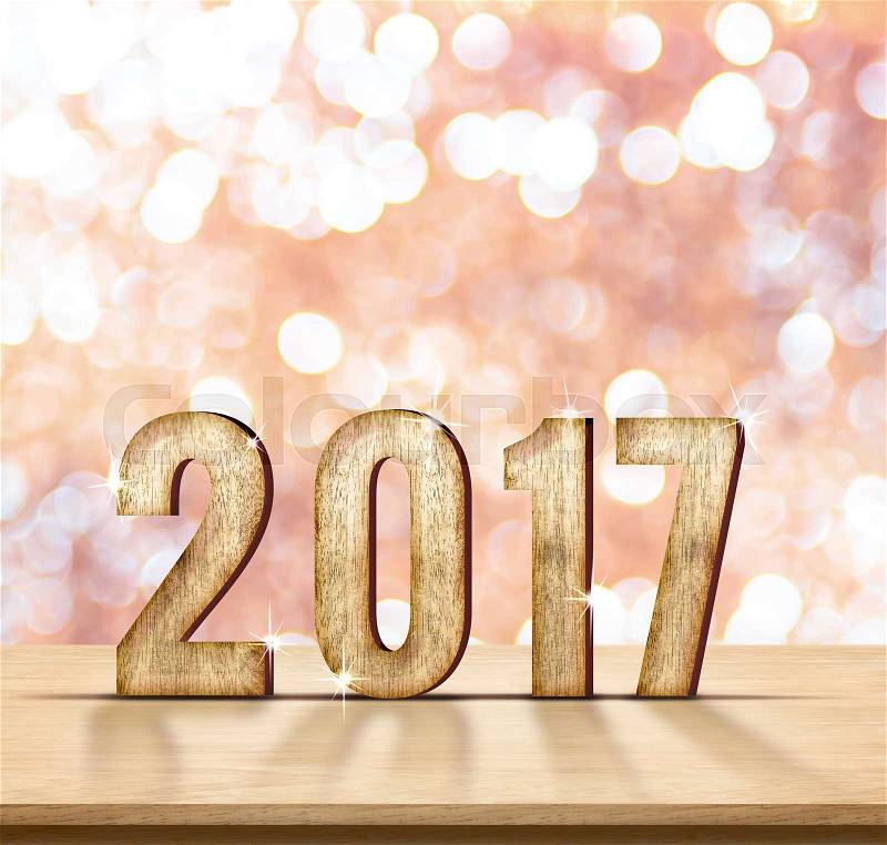 2017 year wood number on wood table with pink sparkling bokeh wall and wooden plank floor,leave space for adding your content, stock photo