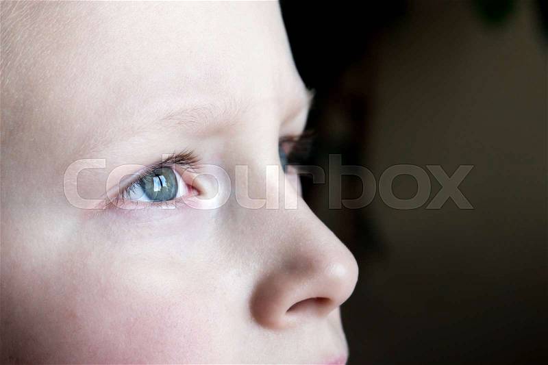Sad children eyes close up - sad, upset blond boy (teen), stock photo