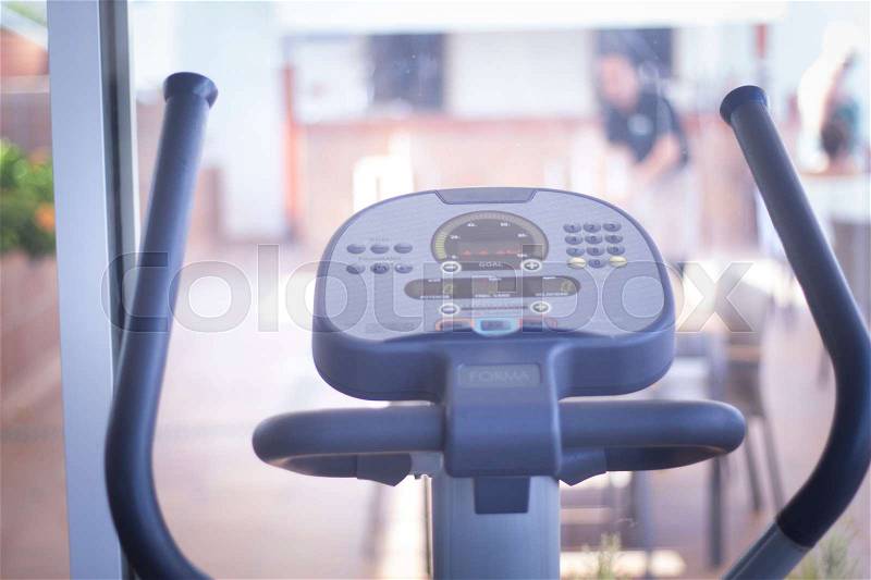 Gym bike exercise cycle machine for static indoor cycling in fitness and aerobic studio, stock photo