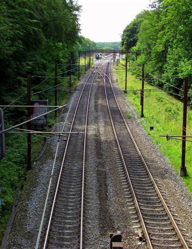 Railroad tracks in a forest , seen from above , stock photo