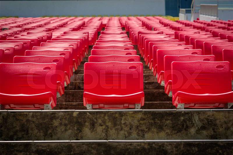 Empty red seats in football stadium, stock photo