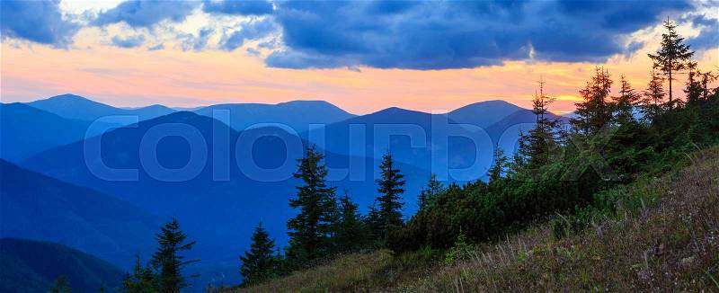 Mountain outline on evening sky (with clouds) background. Summer sunset twilight view (Carpathians, Ukraine), stock photo