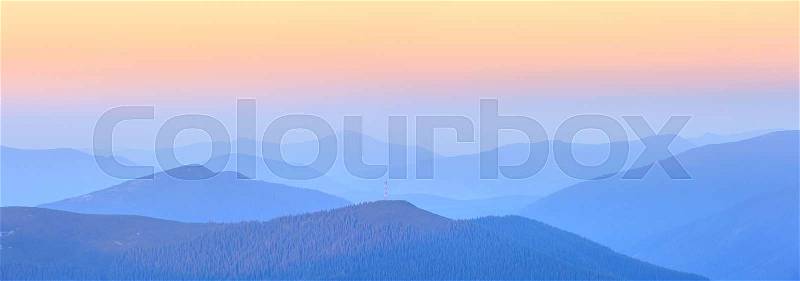 Mountain outline on morning sky background. Summer daybreak misty top view (Gorgany, Carpathians, Ukraine), stock photo