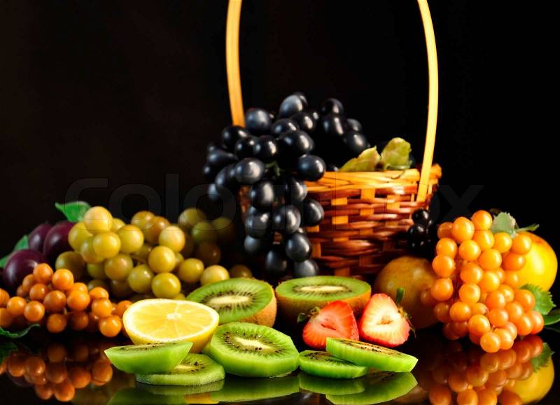Assortment of fresh fruits on black background, stock photo