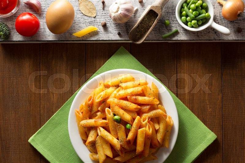 Ready pasta on wooden background, stock photo