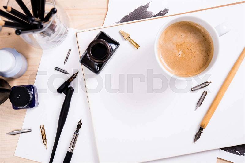 Artist\'s desk and workspace. Paper, ink and calligraphy pens. Creative process, lettering art workshop details with copyspace, stock photo