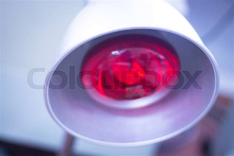 Physical therapy equipment in physiotherapy center and medical clinic for red heat light treatment for injuries, stock photo