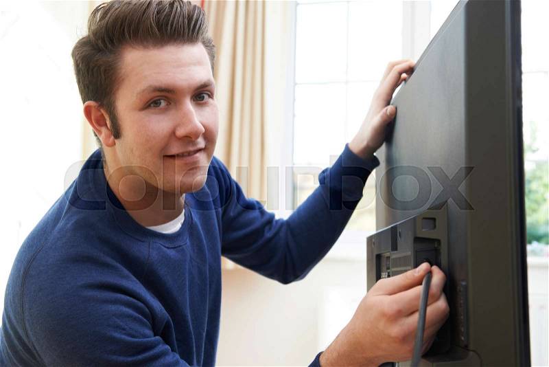 Television Engineer Installing New Television At Home, stock photo