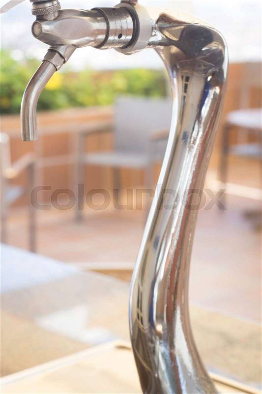 Beer pump on outdoor terrace in restaurant bar in Spain in summer, stock photo