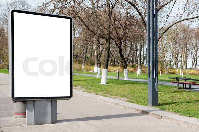 Empty billboard or lightbox on green city street with white isolated background, stock photo