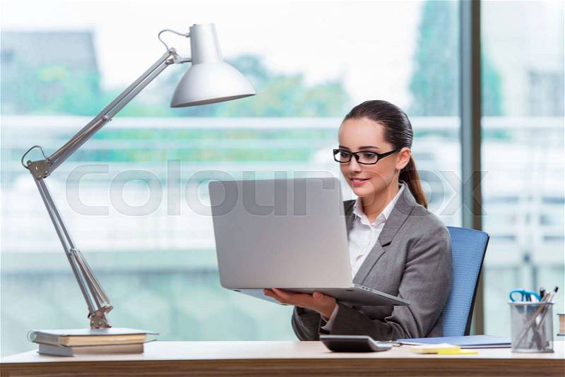 Young assistant working in the office, stock photo