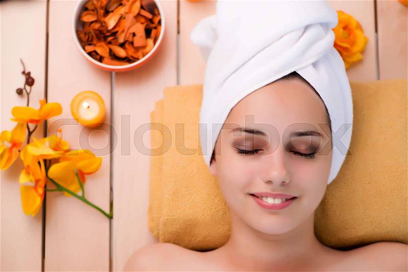 Young woman relaxing in spa in health concept, stock photo