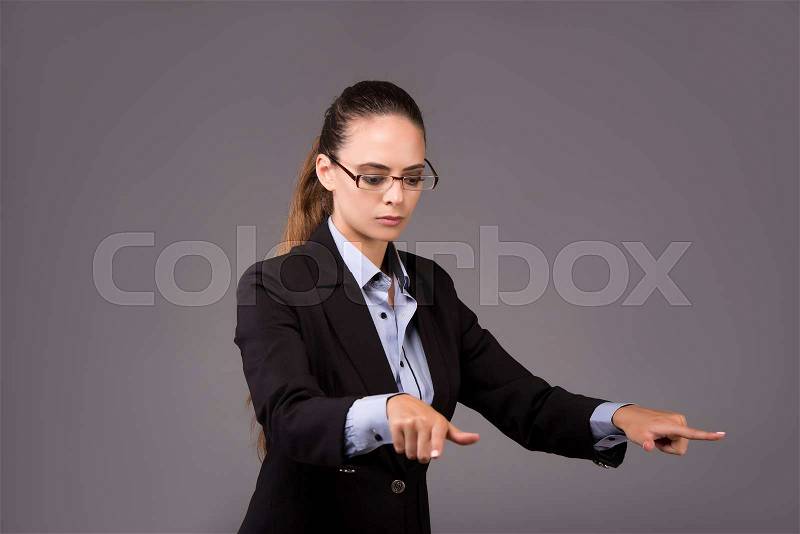 Young woman businesswoman pressing virtual buttons, stock photo