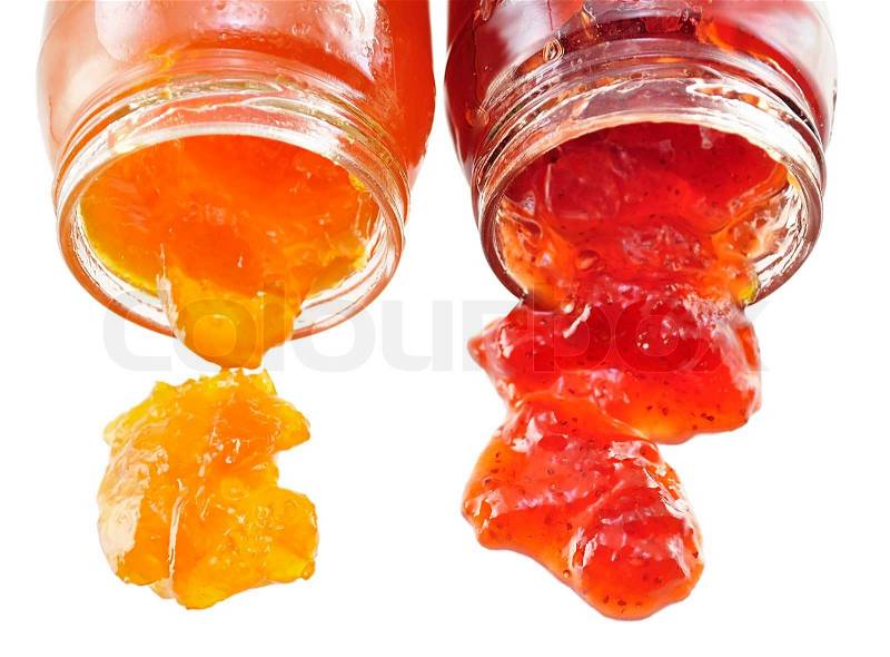 Jars of apricot and strawberry jelly on white background, stock photo