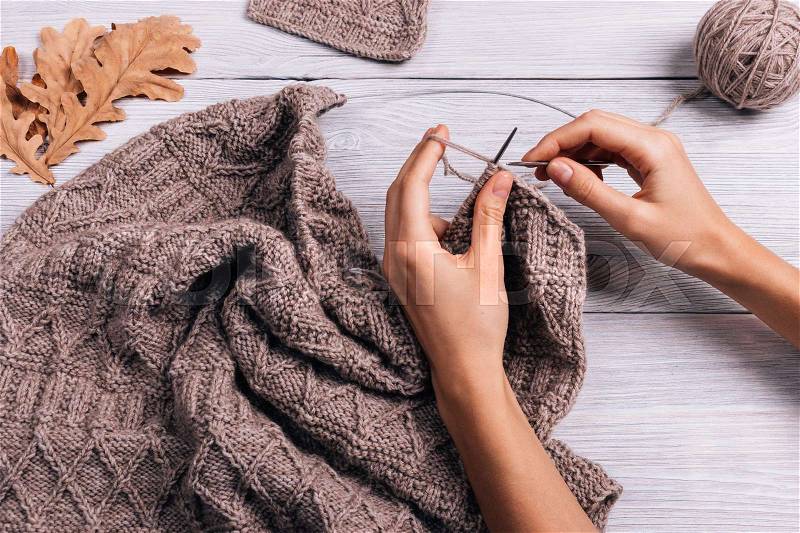 Female hand knit wool sweater, top view, stock photo