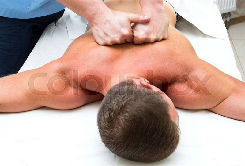 Young man on wellness treatments sports massage, stock photo