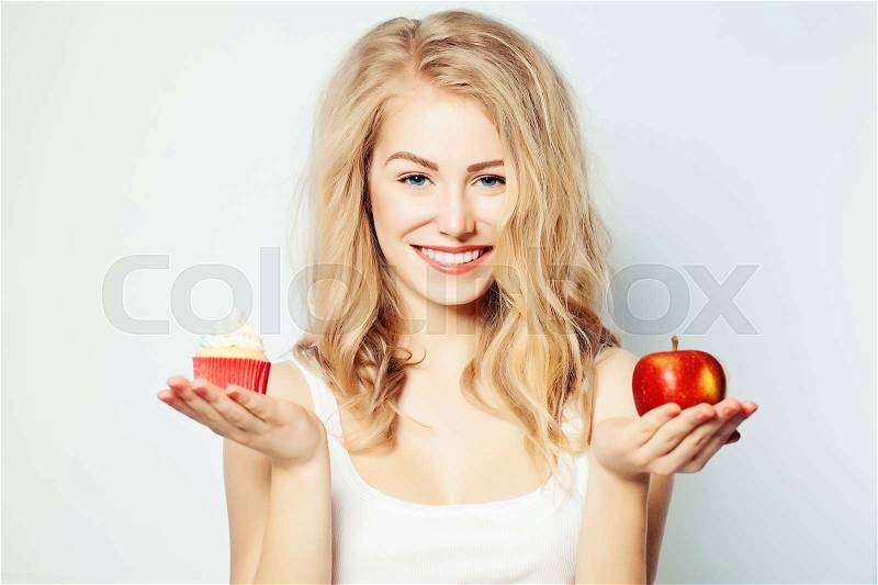 Smiling Woman with Healthy and Unhealthy Food. Difficult choice. Overweight Concept, stock photo
