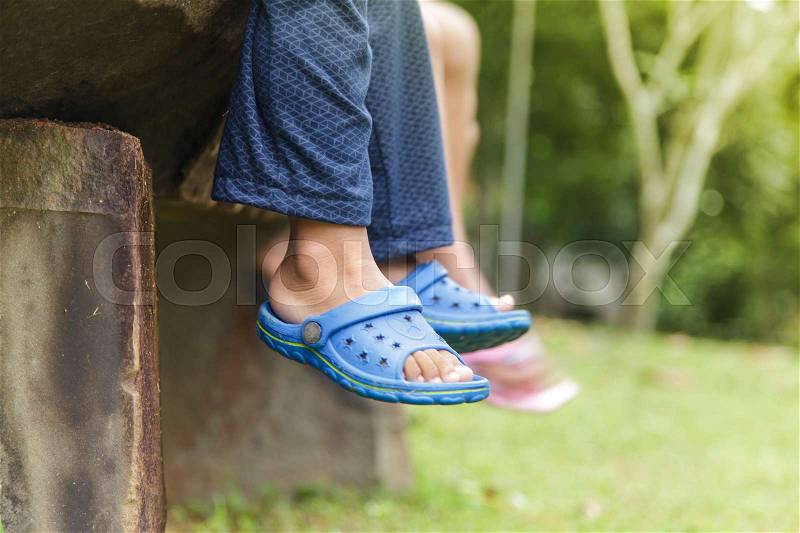 Kids sitting dangling their feet in summer concept for family, friends, stock photo
