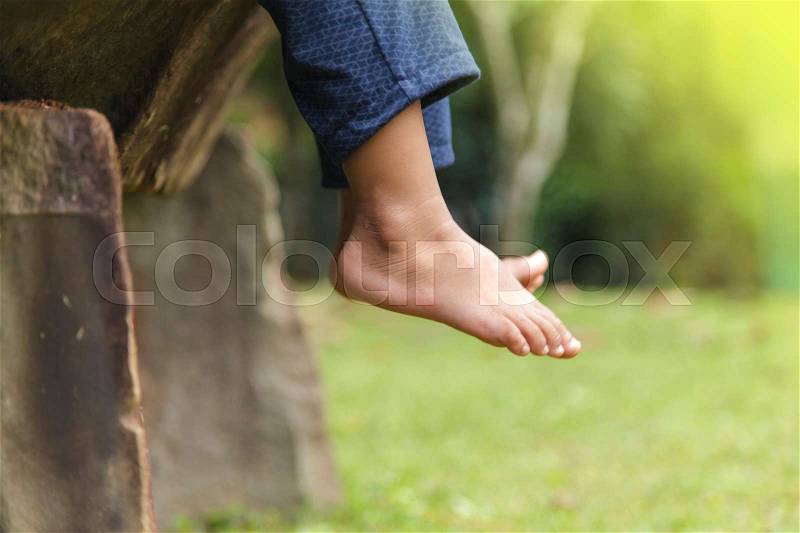 Children legs barefoot, Kids sitting dangling their feet in summer concept for family, friends, stock photo