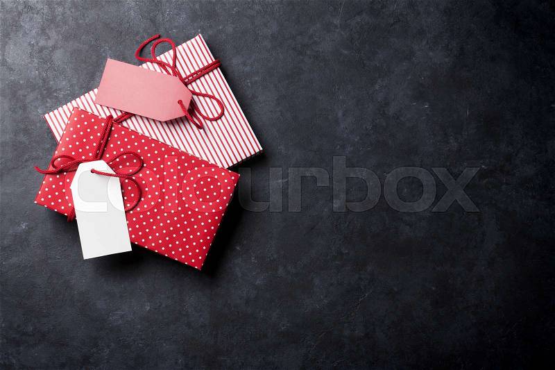 Christmas gift boxes on stone table. Top view with copy space, stock photo