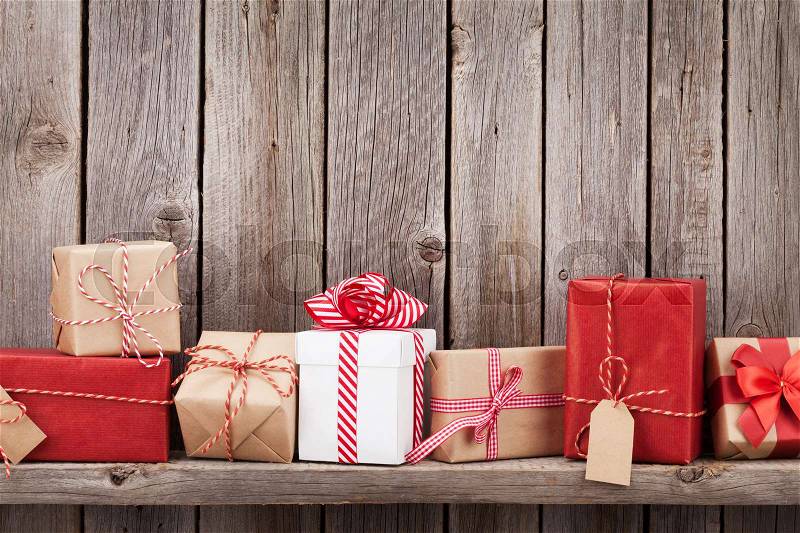 Christmas gift boxes in front of wooden wall. View with copy space for your text, stock photo