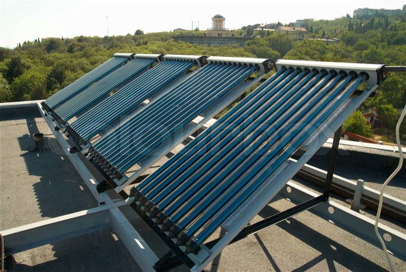 Vacuum solar water heating system on the house roof, stock photo