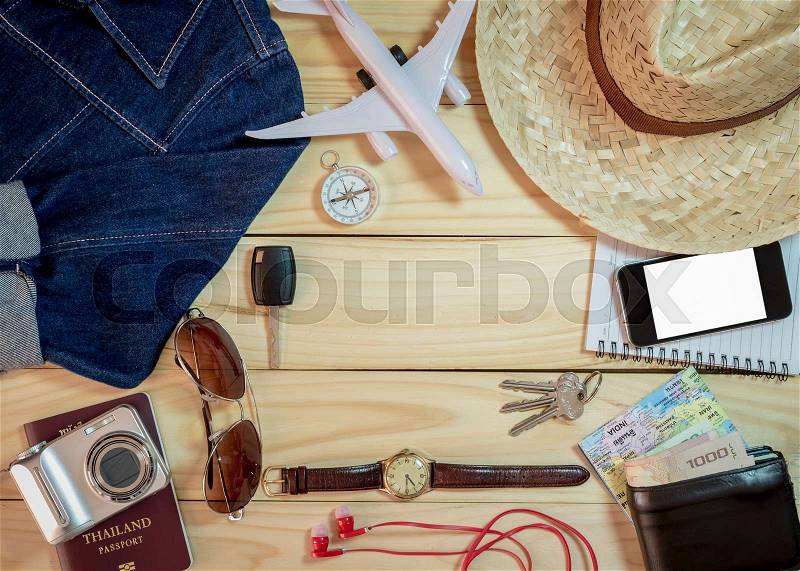 Set of clothes and travel accessory on wooden plank background, Travel concept, stock photo
