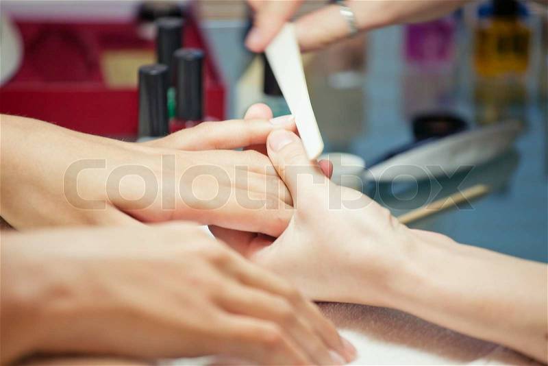 Manicure tool does the correction of nails in a beauty salon manicure, stock photo