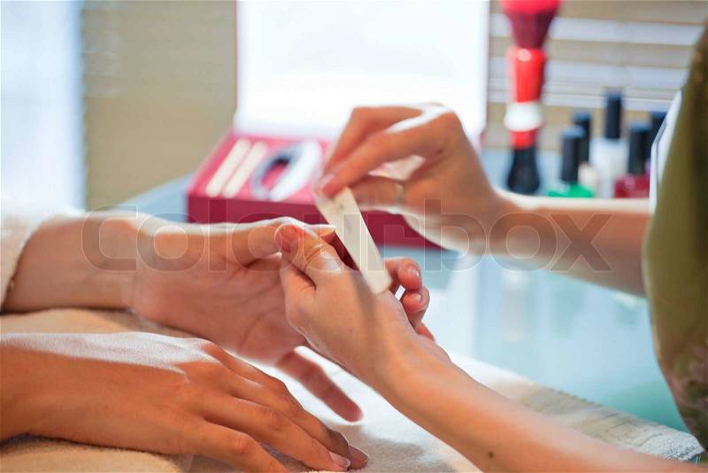 Manicure tool does the correction of nails in a beauty salon manicure, stock photo