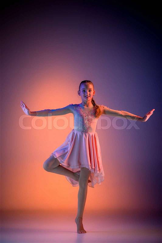 The female teen modern ballet dancer on orange studio background, stock photo