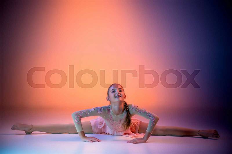 The female teen modern ballet dancer on orange studio background, stock photo