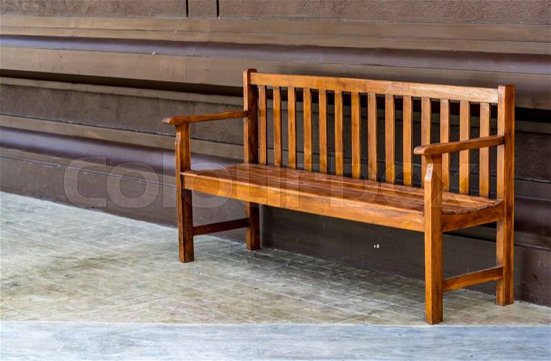 Wooden bench on concrete floor, stock photo