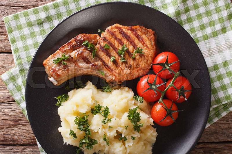 Grilled pork steak with mashed potatoes on a plate close-up. horizontal view from above , stock photo