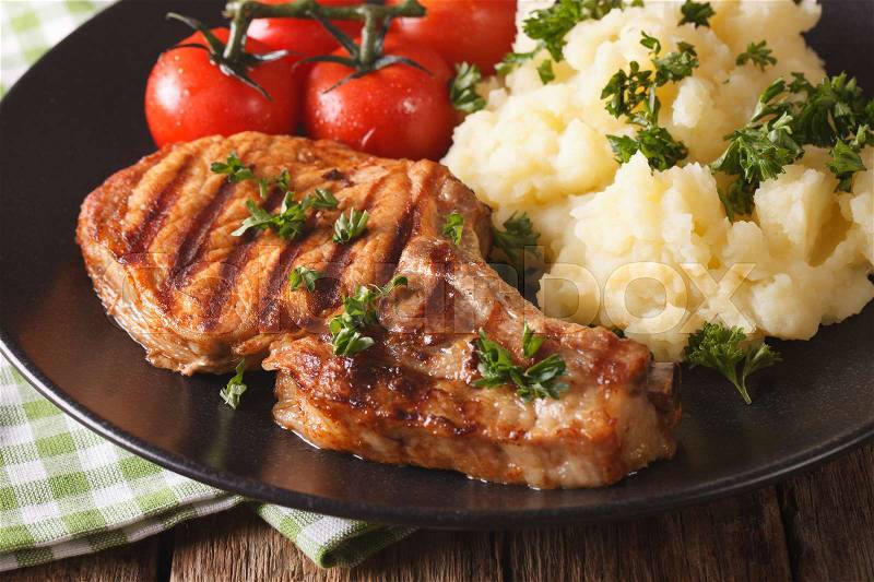 Grilled pork steak with mashed potatoes on a plate close-up. Horizontal , stock photo