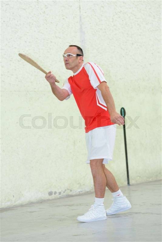 Man playing racket sport, stock photo