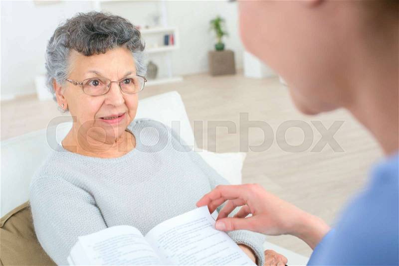 Reading to an old lady, stock photo