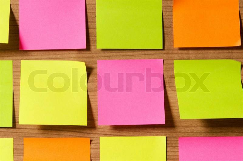 Many reminder notes on the wooden background, stock photo