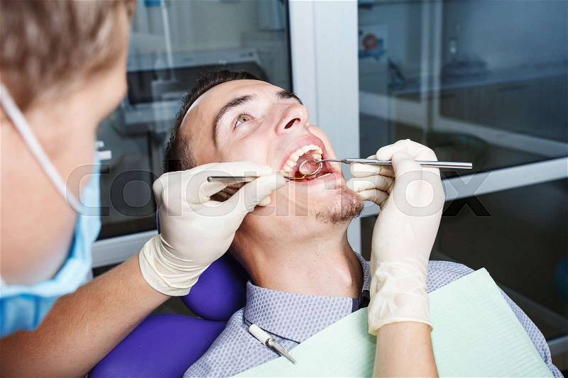 A dentistry, patient examination and treatment at the dentist, stock photo