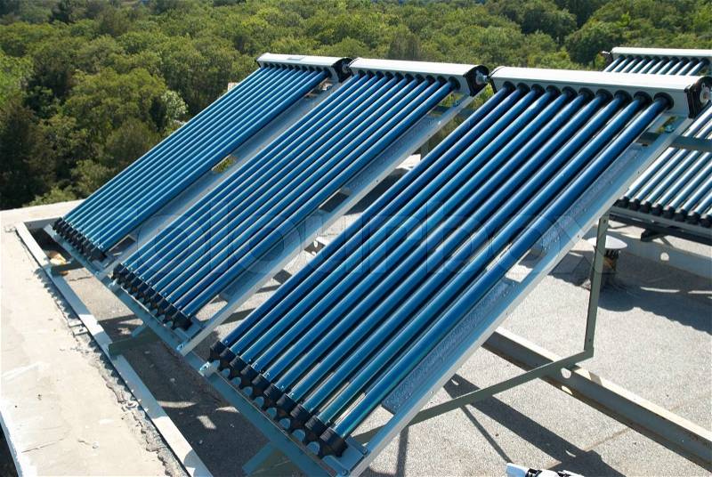 Vacuum solar water heating system on the house roof, stock photo