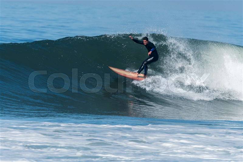 Surfer in action on the ocean waves on a sunny day, stock photo