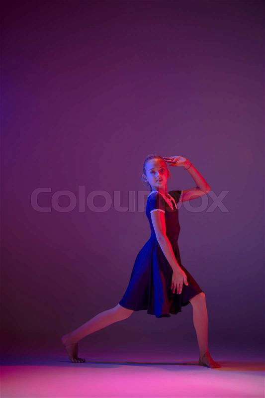 The female teen modern ballet dancer on blue and pink studio background, stock photo