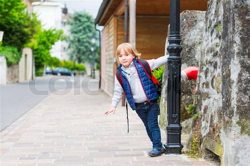 Young boy with backpack ready to go back to school, stock photo