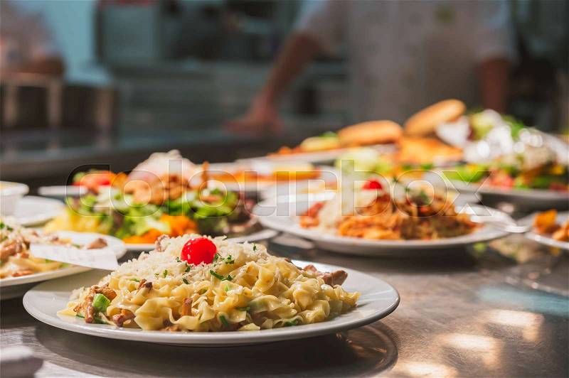 Food orders on the kitchen table in the restaurant, stock photo