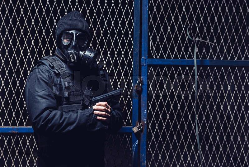 The terrorist with gas mask and gun, stock photo