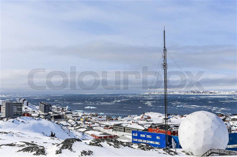 Snow covered city and fjord with icebergs overview, Nuuk, Greenland, stock photo