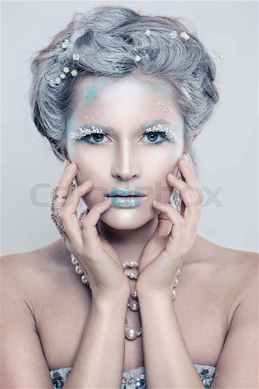 Glamorous Winter Fashion Model Woman with Glitters Makeup. Beautiful Girl with Snow Hair Style and Accessories, stock photo